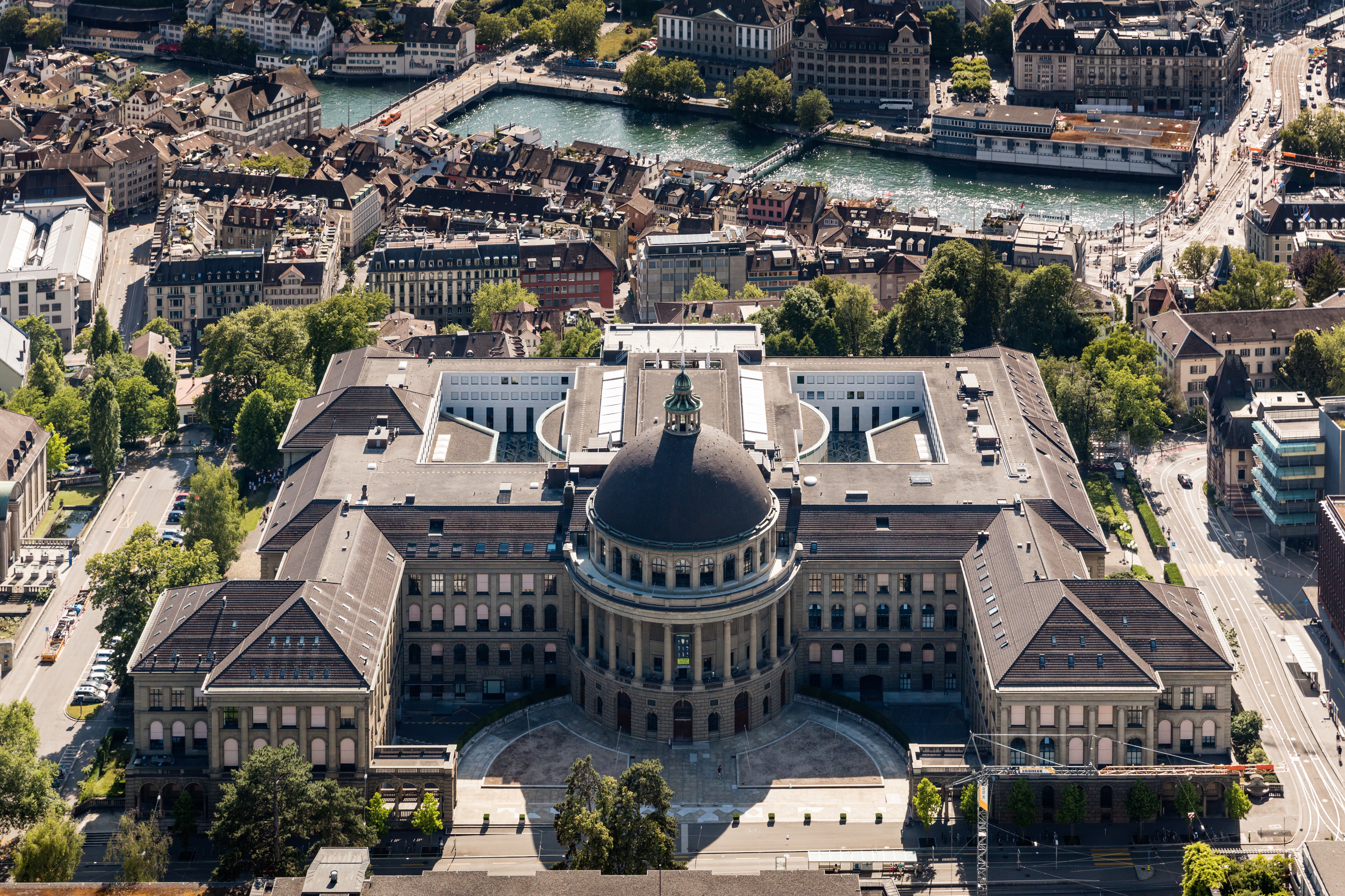 Aerial view of ETH Zurich main building with its iconic dome and symmetrical architecture overlooking the Limmat river and Zurich cityscape