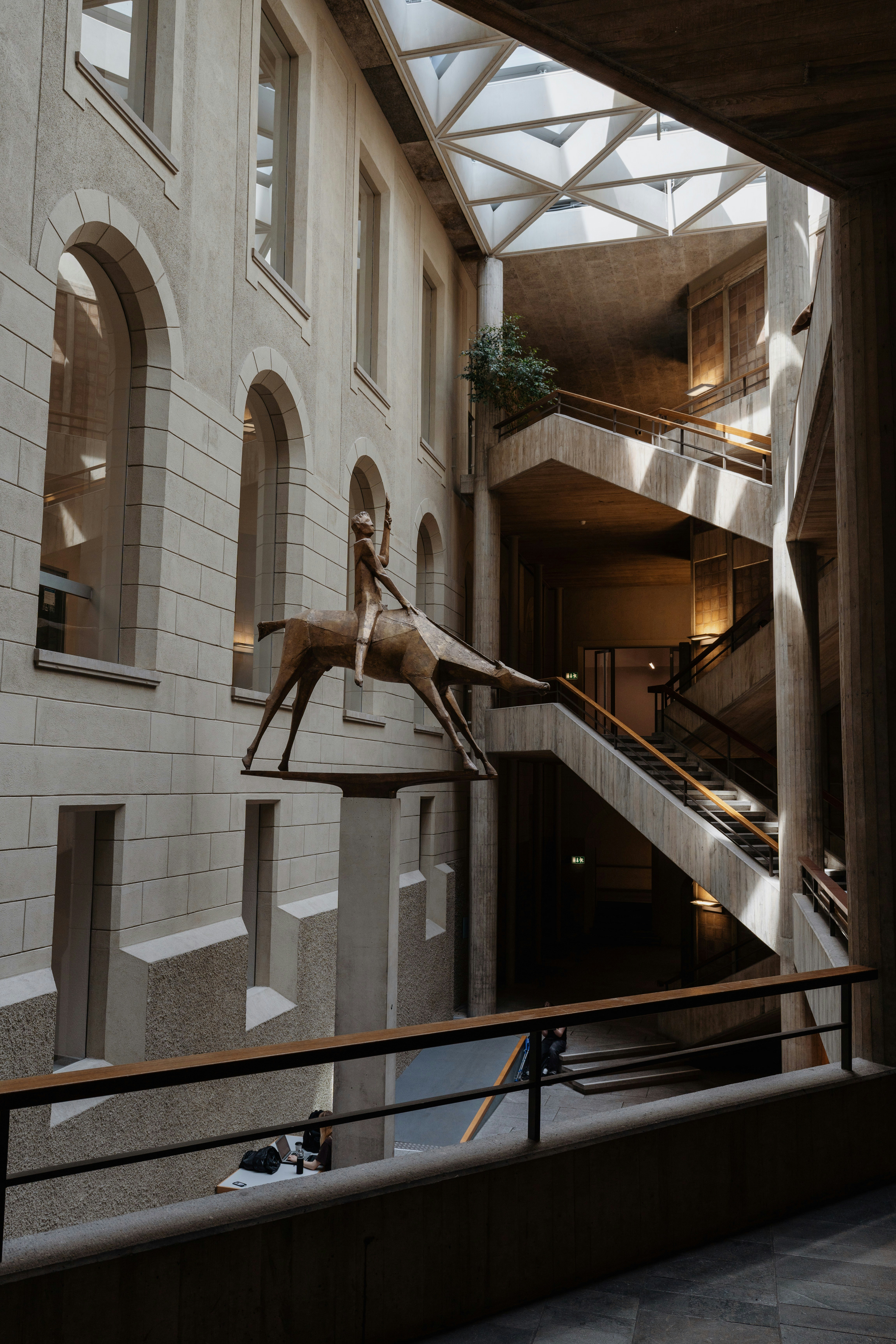 Modern ETH interior featuring bold concrete architecture, geometric staircases, and contemporary art installation